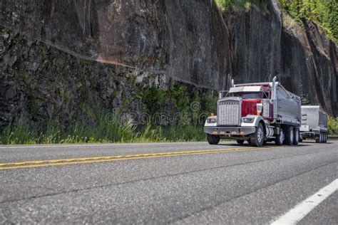 Red Tipper Rig Semi Truck With Two Tip Trailers Driving On The Mountain