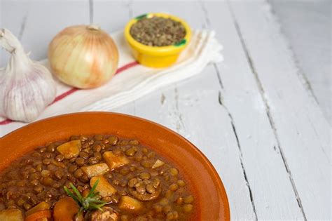 Premium Photo Stew Of Lentils With Chorizo And Pork