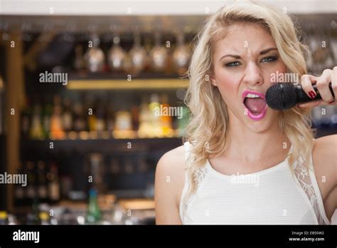 Pretty Blonde Singing With Her Microphone Stock Photo Alamy