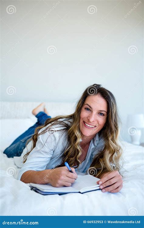 Woman Lying On Her Bed Writing In A Book Stock Image Image Of Biro