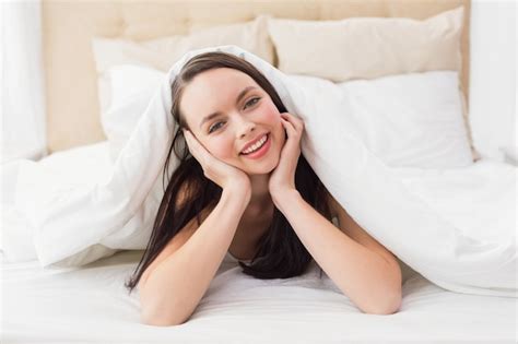 Premium Photo Pretty Brunette Smiling At Camera In Bed
