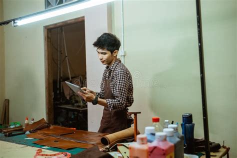 Asian Craftsman Looking Leather Craft Patterns On The Screen Pad Stock