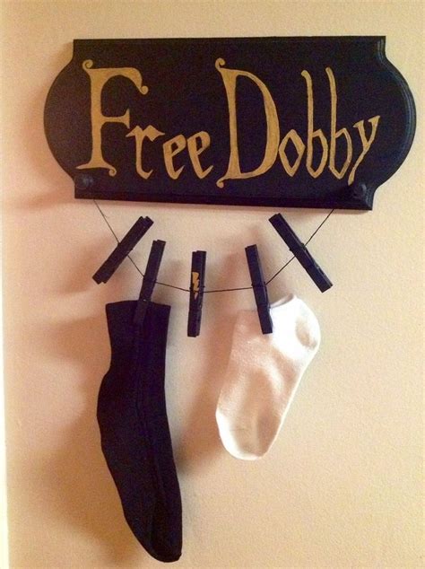 Three Socks Hanging On A Clothes Line With A Free Dobby Sign Above Them