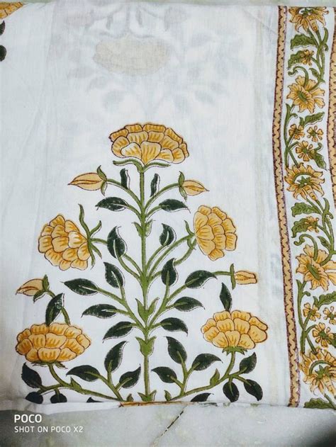 An Embroidered Cloth With Yellow Flowers And Green Leaves On The Side