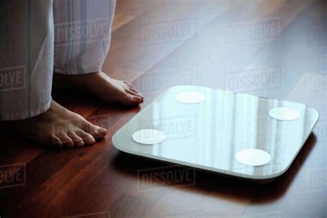 Crop Faceless Barefoot Female In Cozy Pajama Standing On Digital Weight