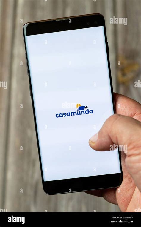 A Mobile Phone Or Cell Phone Being Held In A Hand Showing The Casamundo