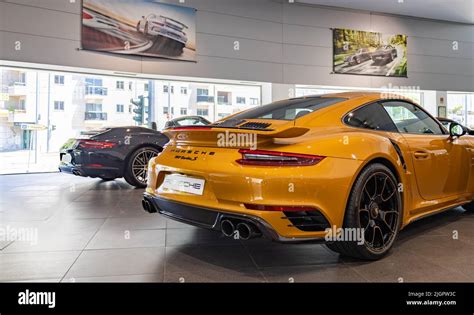 A picture of an orange Porsche 911 Turbo S inside a dealership Stock ...