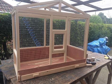 a wooden bird cage sitting on top of a table