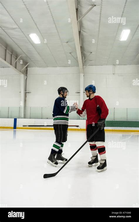 Full Length Of Male Ice Hockey Players Shaking Hands At Rink Stock