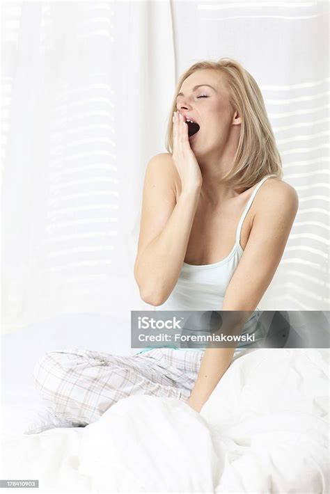 Young Attractive Woman Yawning In Bed Stock Photo Download Image Now