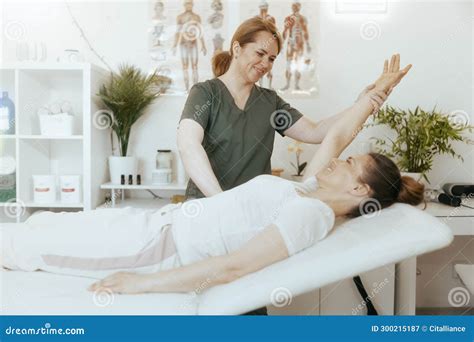 Female Therapist In Massage Cabinet Conducting Examination Stock Image