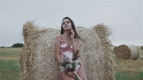 Lady In Blowing Dress With Naked Slim Legs Caresses Neck Seductively At