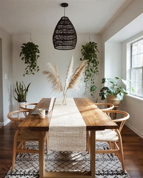 A Dining Room Table And Chairs With Plants On The Wall