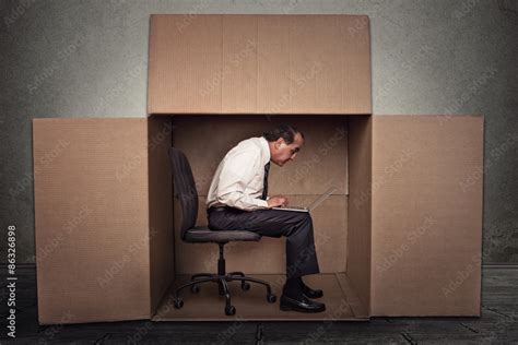 Man Sitting In A Box Working On Laptop Computer Stock Foto Adobe Stock