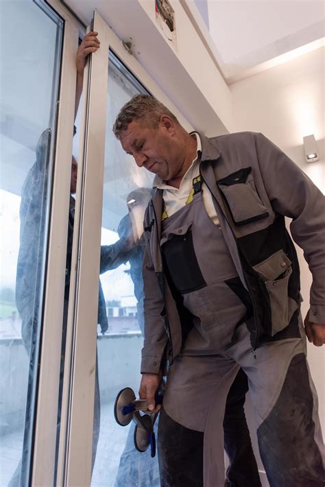 carpenters installing a balcony door 11928743 Stock Photo at Vecteezy