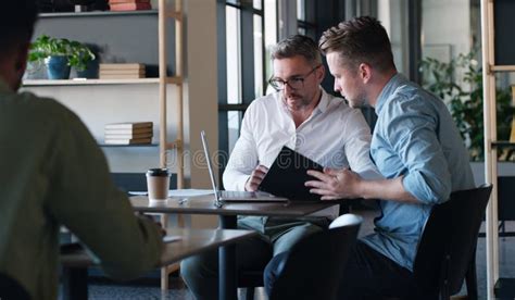 Working Together Makes Business Better Two Businessmen Using A Laptop