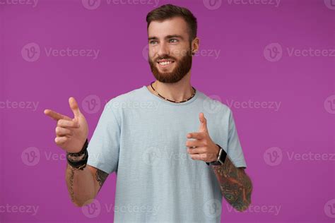 Positive Pretty Tattooed Brunette Guy With Trendy Haircut Wearing Blue