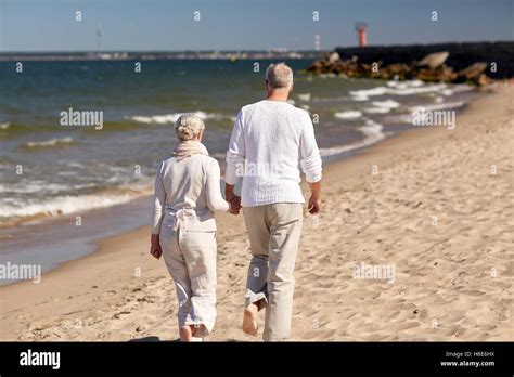 Old Couple Walking Along Beach Hi Res Stock Photography And Images Alamy