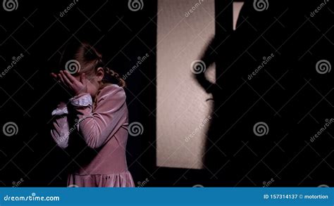 girl afraid  dark male silhouette opening room door horror