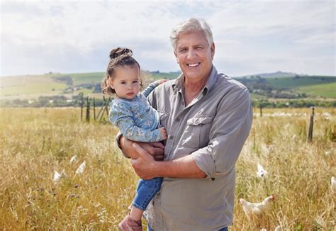 Premium Photo She Loves Visiting My Farm Shot Of A Mature Man Bonding With His Granddaughter
