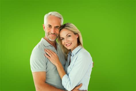 Premium Photo Happy Couple Standing And Smiling At Camera Against