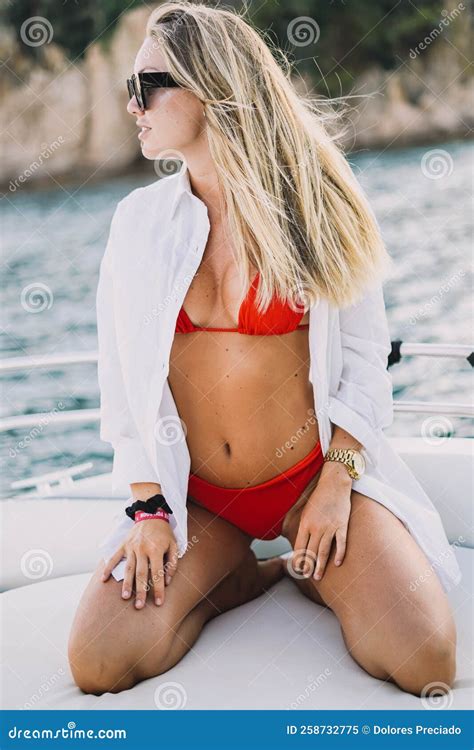 Blonde Model With A Red Bikini And Sunglasses On A Boat Ride Stock