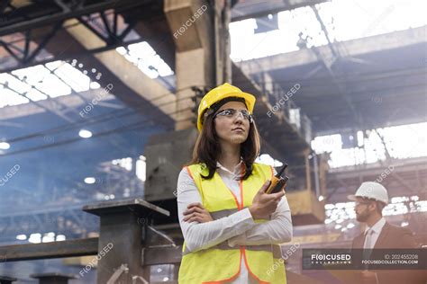 Female Steel Worker With Walkie Talkie In Factory — Goggles Engineer