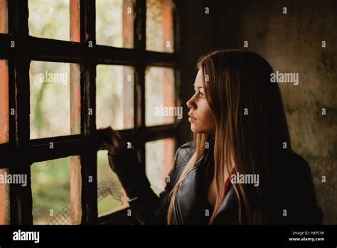 Pensive Blonde Woman Next To A Vintage Windows Stock Photo Alamy