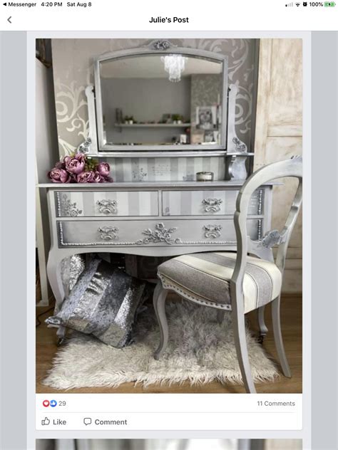 A White Chair Sitting Next To A Desk With A Mirror On Top Of It