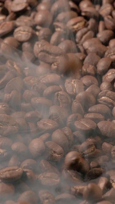 Vertical Slow Motion Of Roasted Coffee Beans Falling Organic Coffee