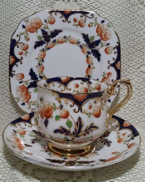 An Ornately Decorated Tea Cup And Saucer With Gold Trimmings On It