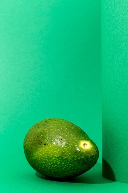 Premium Photo Fresh Avocados On Green Background