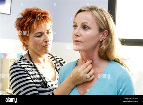 Doctor Examining The Thyroid Gland Of A Patient Stock Photo Alamy