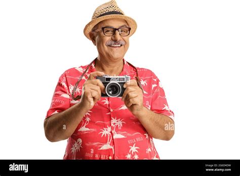 Mature Male Tourist Holding A Camera And Smiling Isolated On White