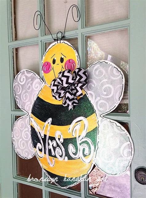 A Decorated Door Hanger With A Bee On It S Side And The Words Bee