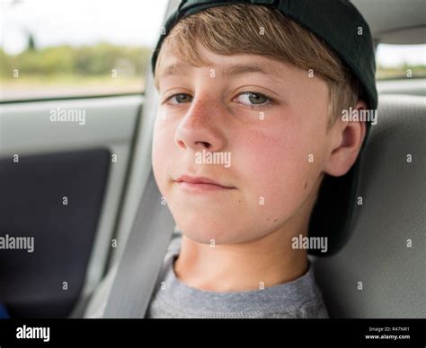 Close Up Portrait Of Casual Teenage Boy With Backwards Hat Stock Photo