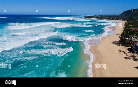 Aerial view of bright blue water and surf with waves crashing at Bonzai ...