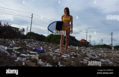 Sexy Woman In Bikini Walk On Beach With Plastic Waste Pollution Holding