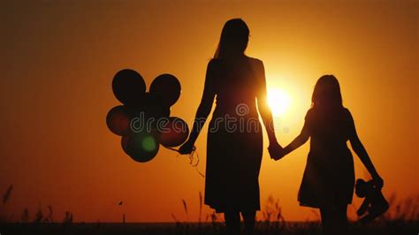 Mom And Daughter Walking At Sunset Air Balloon And Teddy Bear Are