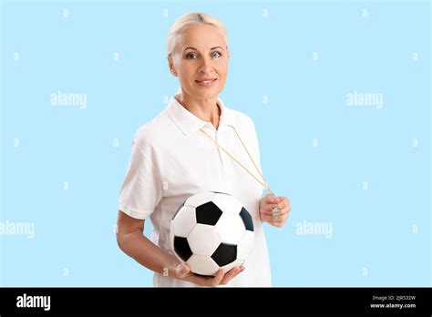 Mature PE Teacher With Soccer Ball On Blue Background Stock Photo Alamy