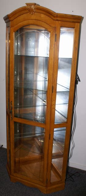 Lighted Etched Glass Front Oak Corner Curio Cabinet By Pulaski Furniture