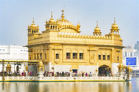 Tourists and pilgrims waiting in line at the entrance The Harmandir ...