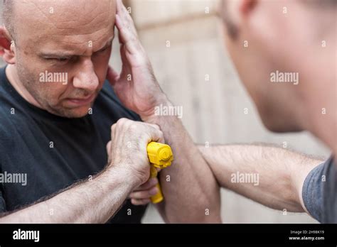 Kapap Instructor Demonstrates Self Defense Techniques Against A Gun Point Gun Disarm Stock