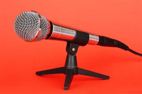 Premium Photo | Microphone on stand on red background