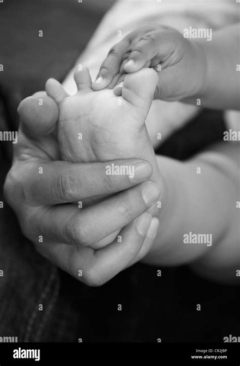 Parents Hands Hold Baby Boy Legs Stock Photo Alamy