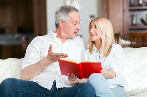 Premium Photo Mature Couple Reading A Book Together