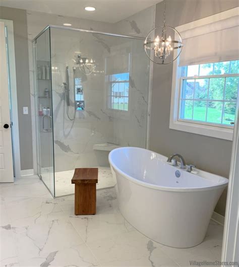 A Large White Bath Tub Sitting Inside Of A Bathroom Next To A Walk In