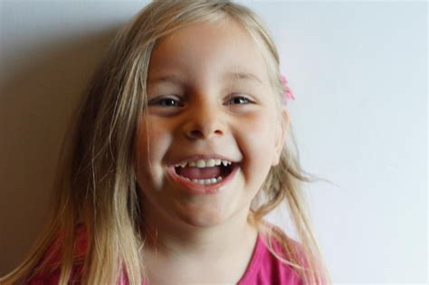 Premium Photo Close Up Portrait Of Cute Girl Smiling Against White