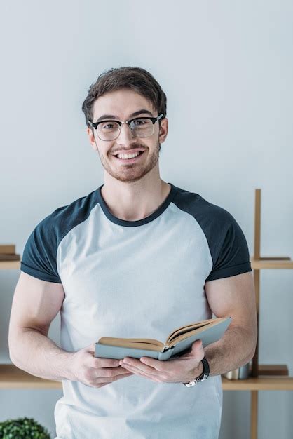 Premium Photo Cheerful Handsome Student Holding Book