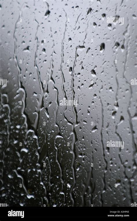 Rain drops running down a glass window Stock Photo - Alamy